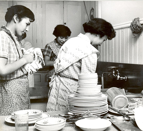Students washing dishes in the kitchen, Portage la Prairie Indian Residential School.