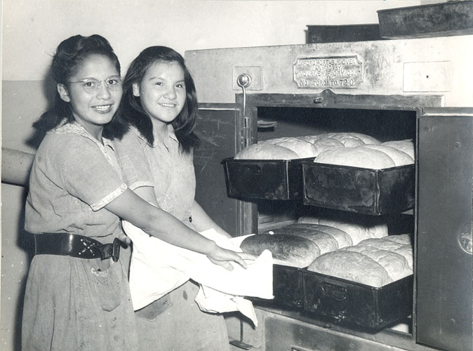 Girls baking bread, Portage la Prairie Indian Residential School.