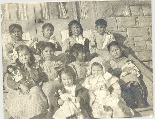 Young pupils at Red Deer Institute. Each girl has a doll which came as presents from the East.