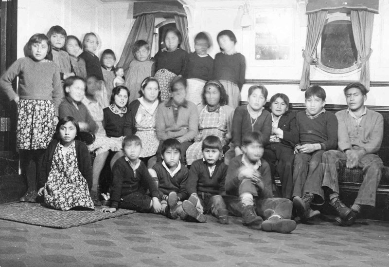 Students sitting in a room at the residential school.