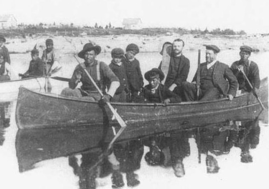 Principle Thompson Ferrier taking children to school in a canoe.