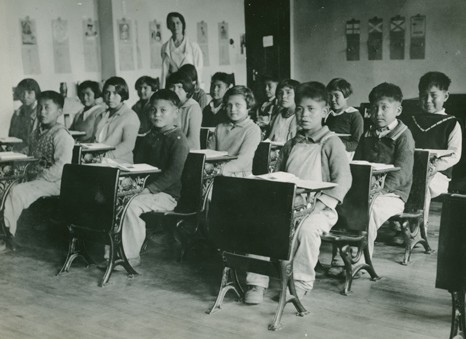 Children sitting in a classroom.