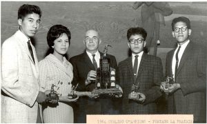 Curling champions holding trophies, caption reads 1964 Curling Champions - Portage la Prairie