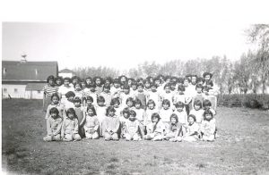 Group portrait on lawn of 62 girls