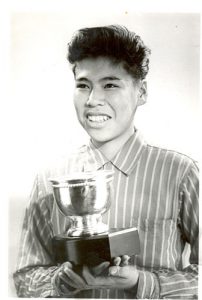 Unidentified student holding trophy, Portage la Prairie Indian Residential School.