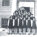 Children dressed for church standing on steps of Portage la Prairie Residential School