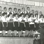 Choir performing in two rows on stage
