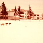 New day school block with dog sled in foreground.