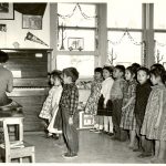 Children performing a song with actions, Norway House Indian Residential School.