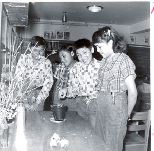 Four students in a classroom at Norway House Indian Residential School.
