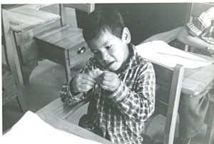 Student shaping his play dough during art class, Norway House Indian Residential School.