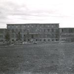 Exterior view of Norway House Residential School building in the distance.