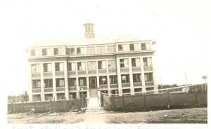 Exterior view of Norway House Residential School showing fence and gate.