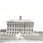 Exterior view of Norway House Residential School building showing fence.