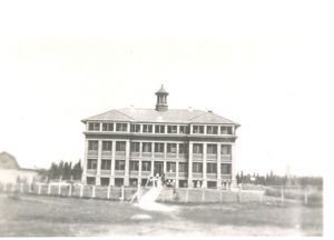 Exterior view of Norway House Residential School building showing fence.
