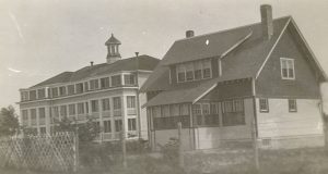 Exterior view showing staff residence on right of Norway House Residential School building.