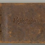 Cover of a photo album made out of brown leather with string binding. The word Photographs is embossed at centre.