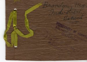 Wooden souvenir booklet cover with a yellow ribbon to hold pages together.