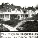 Port Simpson General Hospital on the left with Nurses Residence on the right, and paths leading to and from the buildings, and lawn.