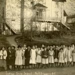 Children and staff standing in line for portrait in front of the Port Simpson Residential School