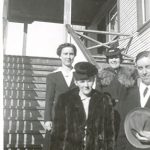 Four staff on stairs of the Port Simpson Residential School