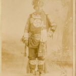 Portrait of Saulteaux person with tree background, caption reads 