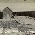 Barn surrounded by building materials, caption read 