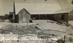 Barn surrounded by building materials, caption read 