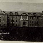 Front of the exterior of the institution building. The name and date are handwritten in white in the bottom left hand corner.