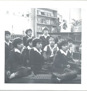 Children sitting on carpet listening to story