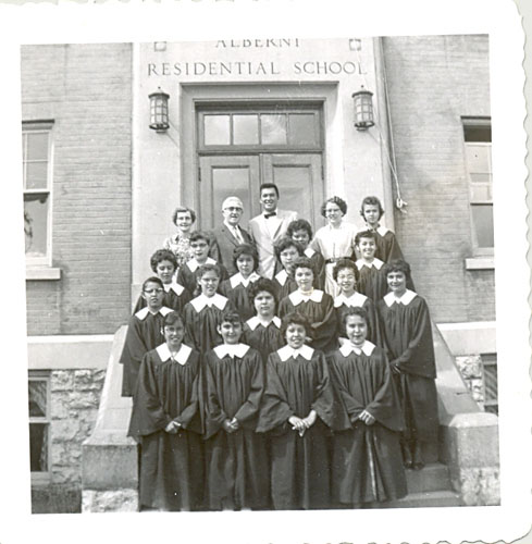 Children in robes and staff standing on steps of Alberni Residential School