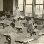 Boys and girls writing at desks, Morley Indian Residential School, 1945.