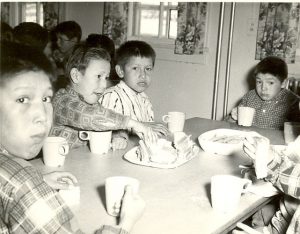Boys eating lunch around table