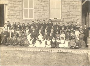 Portrait of large group of children and staff