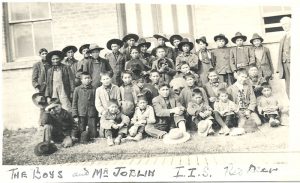 Youth, many in hats, with staff member, caption reads 