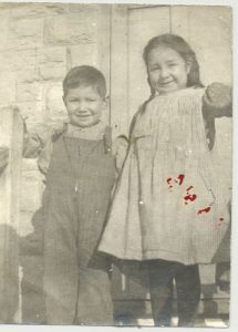 Two young children standing together