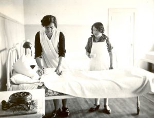 Student assists nurse in caring for sick boy, Edmonton Indian Residential School.