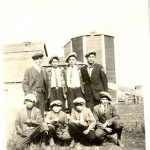 Eight youth wearing caps in field