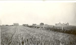 Edmonton Residential School buildings and property taken from far away across a field.
