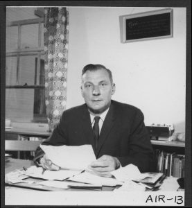 Resident principal, at his desk