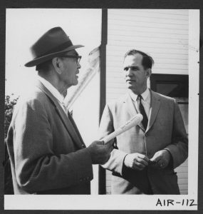 Rev. F. E. (Ed) Kempling and Mr. Jack Peters standing outdoors, mid-conversation.