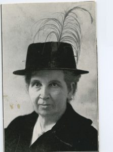 Portrait of Miss E. McKinley wearing a hat with a feather.