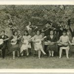 Group of children, seated and standing posed with musical instruments.