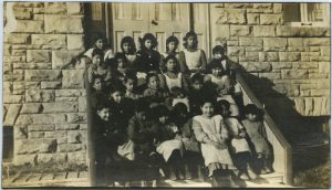 Children sitting on steps of Red Deer Industrial Institute