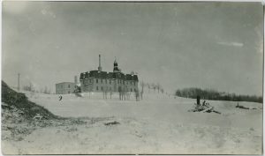 Brandon Residential School on top of a hill, taken in winter.