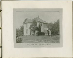 Large house and lawn, trees, caption reads 