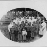 Children and staff standing posted in front of Kitimaat Residential School.