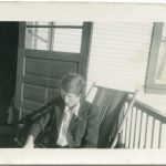 Staff member sitting on chair on veranda