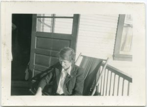 Staff member sitting on chair on veranda