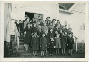 Children and staff standing on stairs of a church
